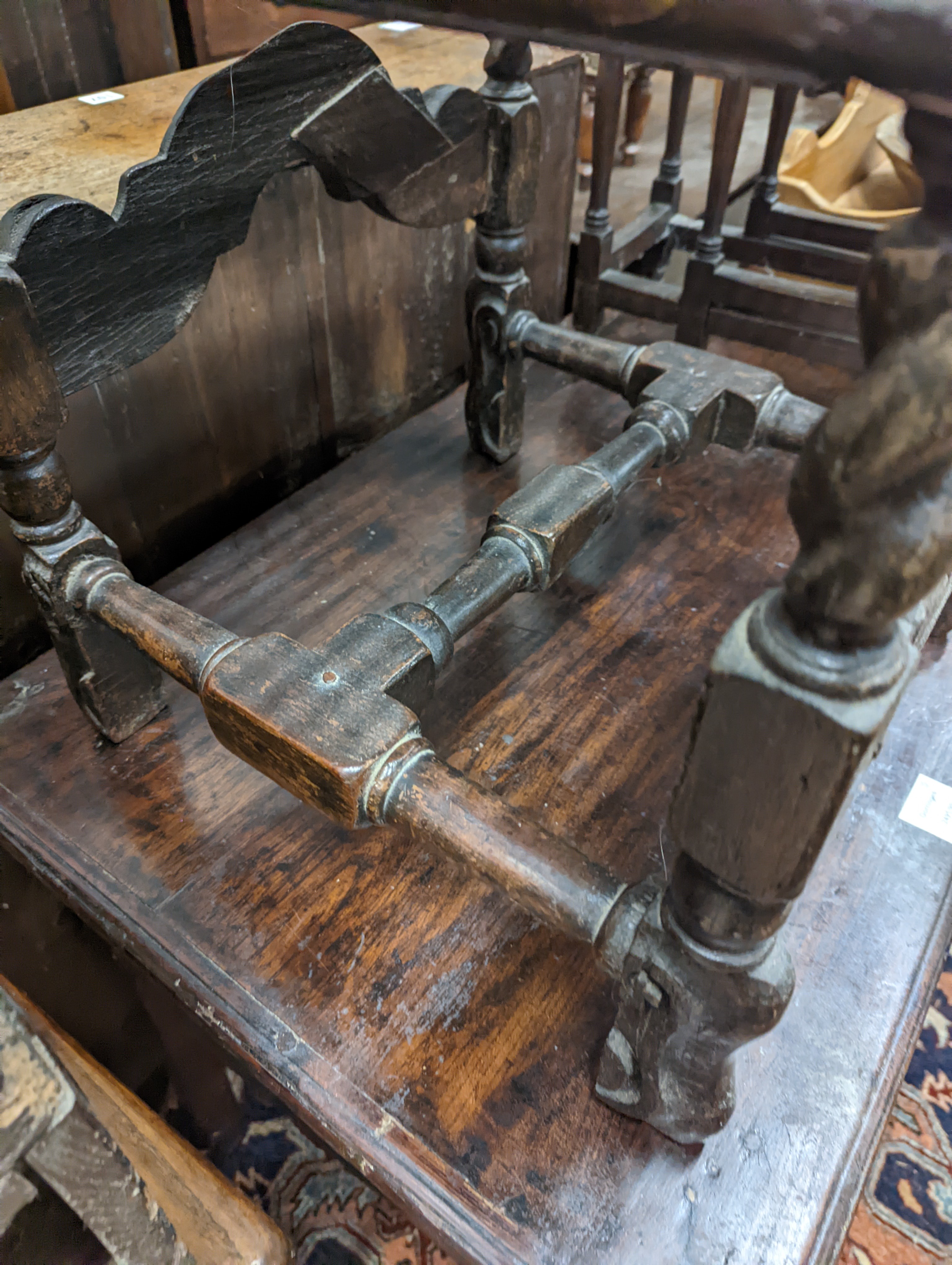 A 17th century style carved oak stool, with caned seat and H stretcher, width 47cm, depth 46cm, height 42cm